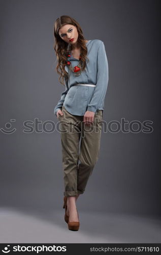 Studio Shot of Trendy Fashion Model in Pants and Blouse