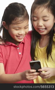 Studio Shot Of Two Chinese Girls With Mobile Phone