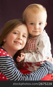 Studio Shot Of Two Sisters Hugging