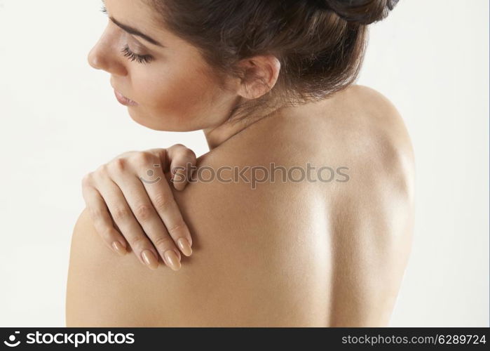 Studio Shot Of Woman With Painful Shoulder