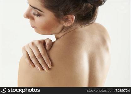 Studio Shot Of Woman With Painful Shoulder