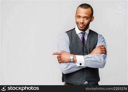 Studio shot of young African-American businessmanman over grey background.. Studio shot of young African-American businessmanman over grey background
