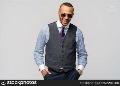 Studio shot of young African-American businessmanman over grey background.. Studio shot of young African-American businessmanman over grey background