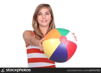 studio shot of young blonde with mutlicoloured balloon