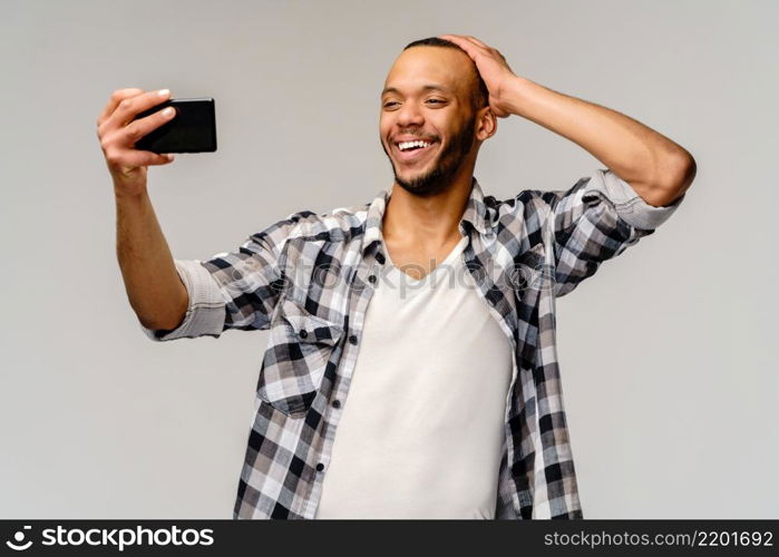 Studio shot of young business man going thumb up on grey background. young business man going thumb up on grey background