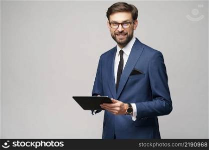 Studio shot of Young Businessman holding digital tablet pc pad. Young Businessman holding digital tablet pc pad