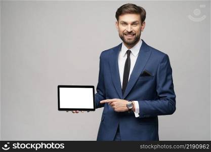 Studio shot of Young Businessman presenting digital tablet pc pad with blank screen. Young Businessman presenting digital tablet pc pad with blank screen