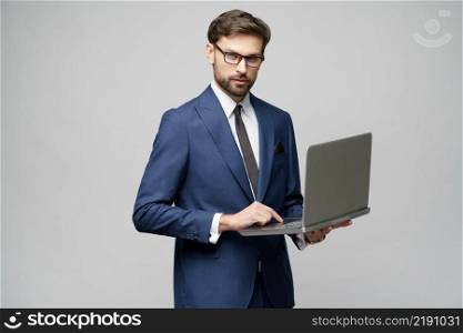 Studio shot of Young handsome businessman Holding a laptop Computer with Blank Screen. Young handsome businessman Holding a laptop Computer with Blank Screen
