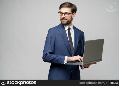 Studio shot of Young handsome businessman Holding a laptop Computer with Blank Screen. Young handsome businessman Holding a laptop Computer with Blank Screen