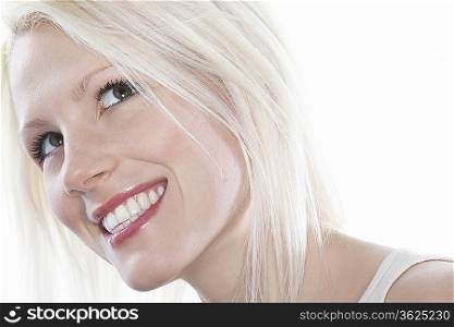 Studio shot of young woman smiling, close-up