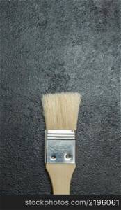 Studio shot paint brush on dark concrete background. Paint brush on dark concrete background