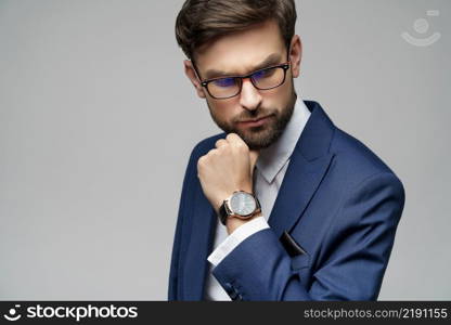 Studuo shot of thinking businessman wearing suit over grey background. Studuo shot of thinking businessman wearing suit