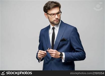 Studuo shot of thinking solving problem businessman wearing suit holding pen over grey background. Studuo shot of thinking solving problem businessman wearing suit holding pen