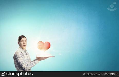 Study affair science. Young man with opened book and red heart on pages
