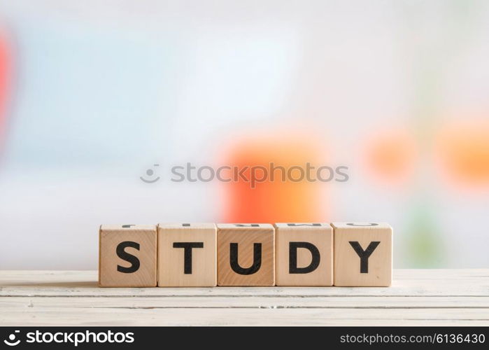 Study sign made of cubes on a wooden table