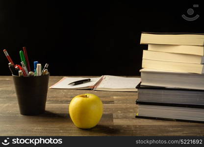 study table desk with books a open sketch book and pencil bucket, university study, school.