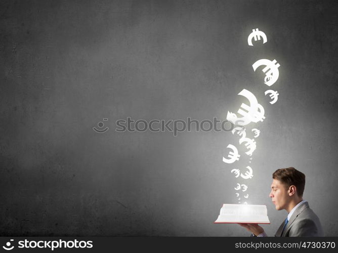 Study to be financial competent. Businessman with book and euro signs flying from pages