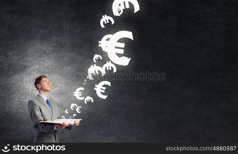 Study to be financial competent. Businessman with book and euro signs flying from pages
