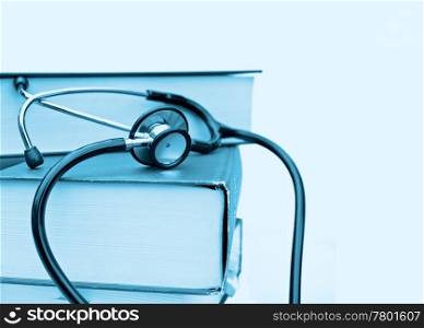 studying medicine or research book with stethoscope on white. books and stethoscope