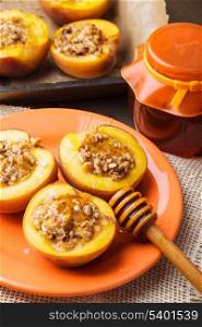 Stuffed Baked Peaches with cookie crumbs and honey drip