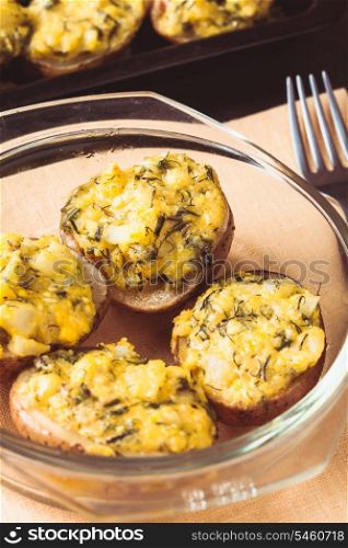 Stuffed baked potato with eggs, cheese and spices