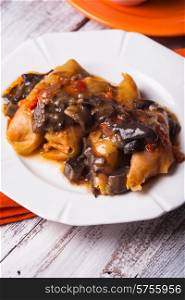 Stuffed cabbage with mushroom sauce on a plate