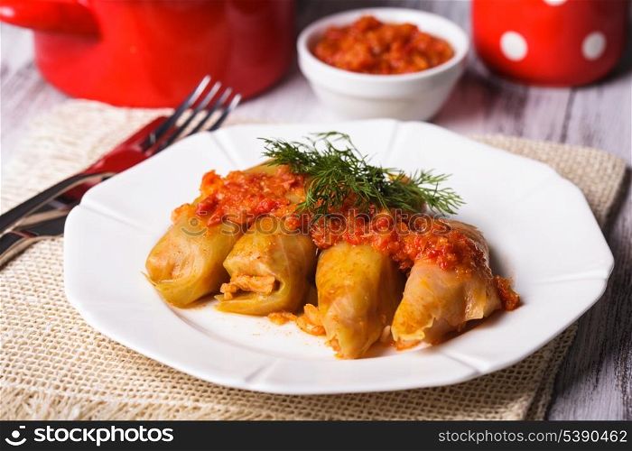 Stuffed cabbage with tomato dip on the plate