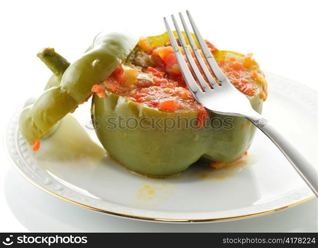 Stuffed green pepper on a plate with fork