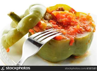 Stuffed green pepper on a plate with fork