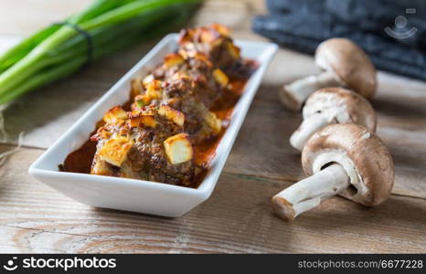 Stuffed mushrooms in a bowl with ingredients.. Stuffed mushrooms in a bowl with ingredients