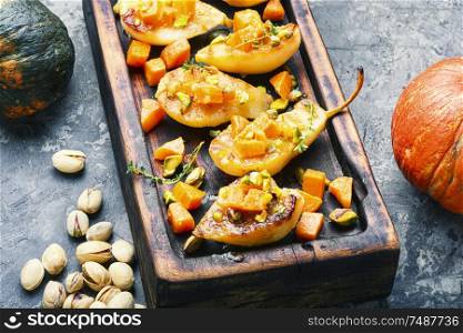 Stuffed pear pumpkin and pistachio.Autumn food.Baked pear dessert. Ripe baked pear with pumpkin