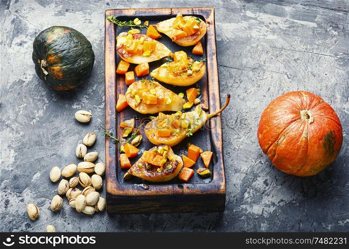 Stuffed pear pumpkin and pistachio. Baked pear. Autumn food.. Sweet baked pears