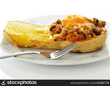 stuffed squash with cheese on a plate with fork
