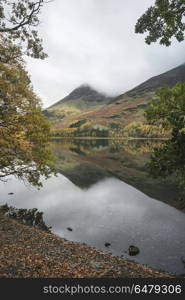 Stuning Autumn Fall landscape image of Lake Buttermere in Lake D. Beautiful Autumn Fall landscape image of Lake Buttermere in Lake District England