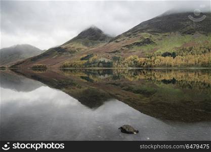 Stuning Autumn Fall landscape image of Lake Buttermere in Lake D. Beautiful Autumn Fall landscape image of Lake Buttermere in Lake District England