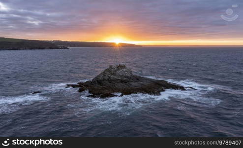 Stunning aerial drone landscape image of Prussia Cove at sunrise in Cornwall England with atmospheric moody sky and clouds