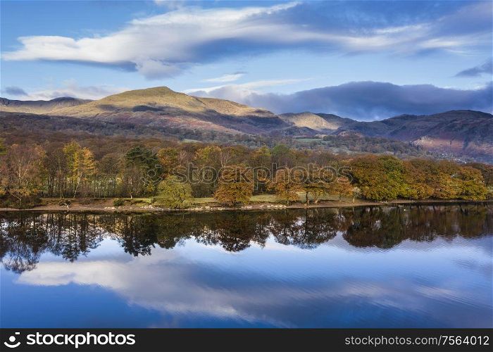 Stunning aerial drone landscape images over Coniston Water at sunrise on beautiful Autumn Fall morning