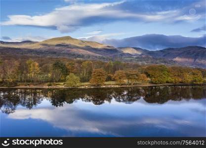 Stunning aerial drone landscape images over Coniston Water at sunrise on beautiful Autumn Fall morning