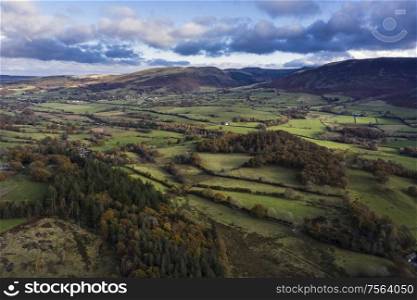 Stunning aerial drone vibrant Autumn Fall landscape image of view from Low Fell in Lake District