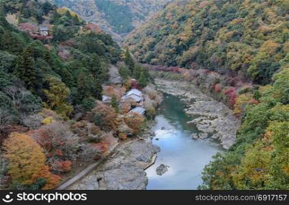 Stunning autumn color landscape of Asashiyama mountain and Hozugawa river in Kyoto, Japan