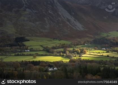 Stunning Autumn Fall landscape view along valley towards Mellbreak and Grasmoor in Lake District with beautiful epic lighting in late afternoon