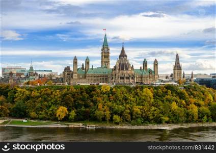 Stunning autumn view of Parliament Hill across the Ottawa River in Ottawa, Canada