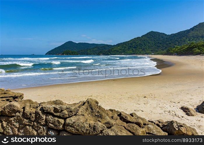 Stunning beach in Bertioga on the north coast of the state of Sao Paulo surrounded by untouched forest and mountains . Stunning beach in Bertioga on the north coast of the state of Sao Paulo