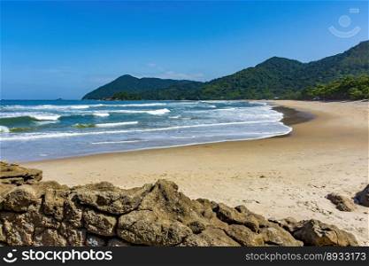 Stunning beach in Bertioga on the north coast of the state of Sao Paulo surrounded by untouched forest and mountains . Stunning beach in Bertioga on the north coast of the state of Sao Paulo
