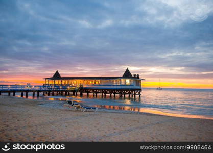 Stunning beautiful sunset on an exotic caribbean beach with cute restaraunt. Amazing beautiful sunset on an exotic caribbean beach