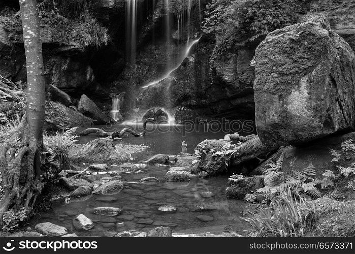 Stunning black and white waterfall landscape at Roughting Linn in Northumberland National Park in England
