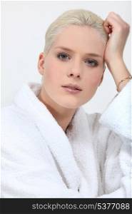 Stunning blonde woman in full make up and a toweling robe