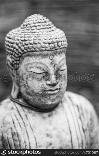 Stunning Buddha statue portrait with shallow depth of field for drawing attention to the face