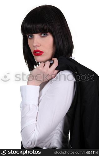 Stunning businesswoman holding her jacket over he shoulder