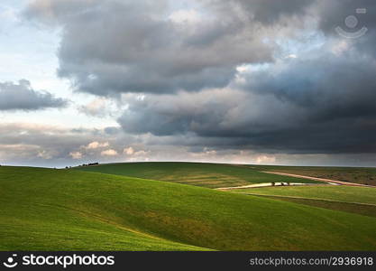 Stunning cloud formations during stormy sky over countryside landscape with vibrant colors